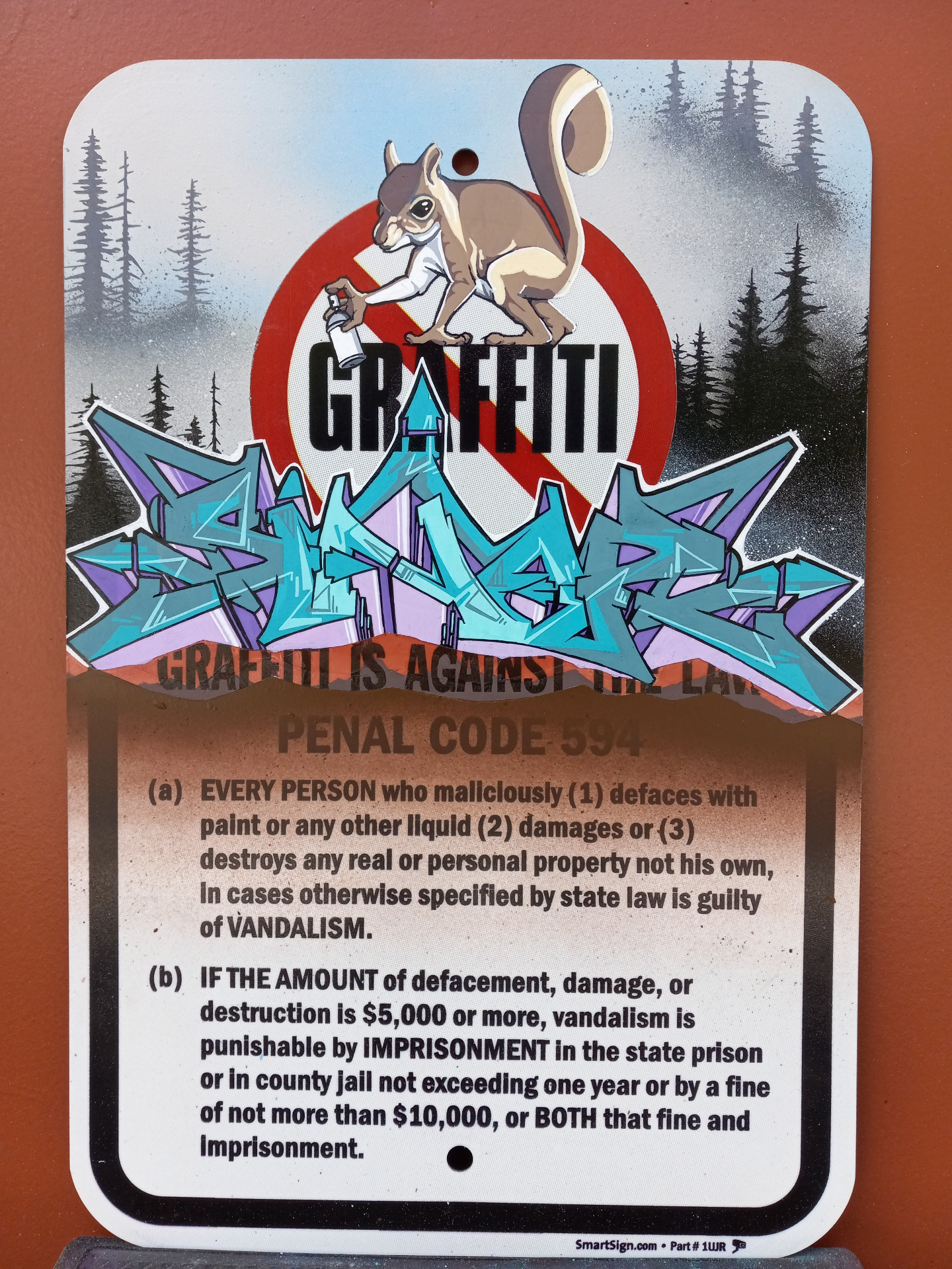 Penal Code 594 sign customized with a squirrel character and teal and purple SINER wildstyle