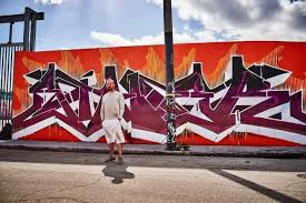 Siner painting live on a festival stage at night