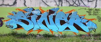 Vibrant pink and orange wildstyle graffiti mural